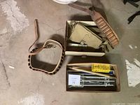 Overview of shotgun shell belt, Naasco cleaning kit case, and additional cleaning accessories on floor.