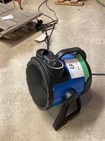 Side view of Mastercraft barrel ceramic utility heater showing control knobs, handle, and front protective grill.