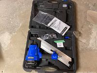 Full view of Mastercraft air-powered clipped-head framing nailer inside black carrying case with manual, safety glasses, and air fitting.