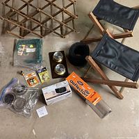 Wide view showing entire lot with all items: Sony boxed alarm clock, stools, wine rack, weather station, deflectors, floor protectors