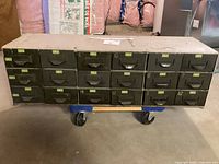 Front view of the vintage metal mechanics cabinet with 18 drawers, showing surface wear and numbered labels on drawers.