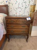 Front full view of oak Federal style bedside table with three drawers, marble top not visible but referenced in description