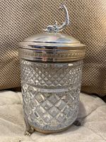 Front view of entire cylindrical glass box with diamond cut pattern and silverplated lid and base including claw feet