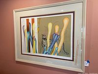 Framed serigraph print with visible signage and clear view of artwork and frame from a side angle.