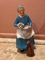 Front view of Royal Doulton The Favourite figurine showing woman in blue dress and cat sitting in front