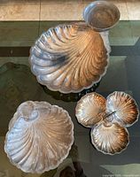 All three trays shown together on glass table, showcasing size differences and design variety