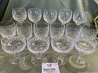 Front angle showing 5 wine glasses in back row, 6 water glasses in middle, and 4 champagne glasses in front