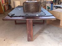 Front view showing rectangular top and central support leg