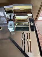 Overview of Citizen watches, several wristwatches with leather bands, and two boxed pens from Cross
