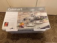 Box top showing Cuisinart Chef's Classic Stainless Cookware 10-piece set with images of pots and pans and product features.