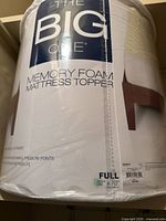 Photo of new The Big One full size memory foam mattress topper showing brand name, size 52 x 78 x 3 inches, and memory foam material.
