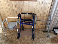 Photo showing all three items in the lot: white potty chair, blue Hugo walker, and gray metal walker.