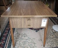 Front view of the wooden side table showing rectangular top and tapered legs.