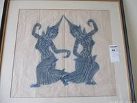 Full view of vintage framed artwork showing two dancing figures with intricate designs.
