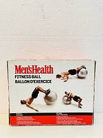 Box front showing Men's Health branding and images of man demonstrating exercises using the fitness ball.