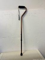 Full view of the height adjustable walking stick with foam handle and strap.