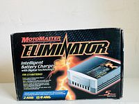 Front of the original box showing the MotoMaster Eliminator branding and key features of the intelligent battery charger.