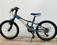 Left side profile of bike showing frame, suspension fork, wheels, and kickstand