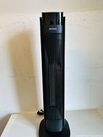 Front view of the NOMA digital tower ceramic heater, showing full height and design with black mesh panel and digital control area.