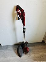 Full view of the Black & Decker corded electric string trimmer showing handle, shaft, trimming head, and guard.