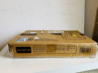 Original packaging box for wooden stool, showing model number and wood type labeling on side.