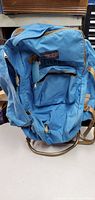 Blue JanSport backpack front side showing front zippered compartments and adjustable straps