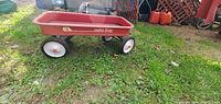 Metal Radio Flyer red wagon from side showing model number 18 and condition.