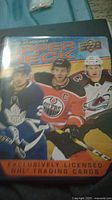 Cover of the binder showing 2020-21 Upper Deck hockey trading cards branding with images of three NHL players on the front.