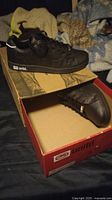 Pair of black Echo United sneakers size 10 placed on foam and inside unltd. branded box.