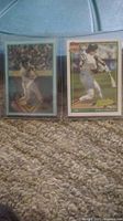 Front view of two Jose Canseco baseball cards side by side, one with lenticular effect showing batting stance, the other showing swing action.
