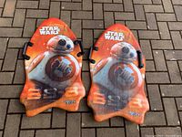 Two Snow Rider snow sleds, top side showing Star Wars BB-8 design, bright orange with handles