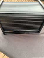 Closed black Beatles CD case with metal The Beatles label