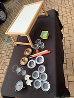 Wooden tray and an assortment of candle holders and candles arranged on a table