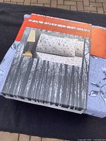 Full flannel sheet set in original unopened box showing the box design with forest tree graphics and pillow with sheet print.