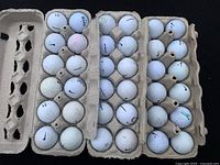 Top-down view of 36 Nike golf balls in three trays showing condition and quantity.