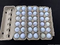 Top-down view of three dozen Precept golf balls in open cardboard trays showing general condition and markings.