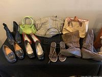Full lot of 4 purses and 5 pairs of shoes displayed on black cloth showing front and top views