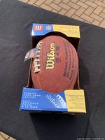 Wilson NFL authentic game football in original packaging showing front with Wilson, NFL, and leather quality labels.