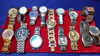 15 assorted random unisex watches displayed on blue and red background, various colors and band types visible.