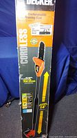 Front view of boxed Black and Decker cordless pruning saw showing pole extension length and branding.