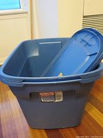 Blue Sterilite storage bin with upright lid showing size and brand label