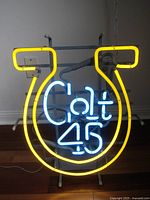 Front view of neon Colt 45 beer sign showing yellow horseshoe and blue "Colt 45" text