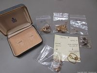 Assorted items in labelled zip bags and Birks box