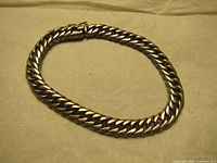 Full view of silver chain link bracelet laid flat to show length and style.