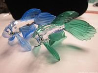 Both crystal fish figurines shown together at an angle