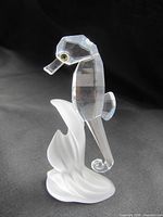 Clear Swarovski crystal seahorse figurine on frosted crystal seaweed base displayed on black background