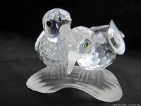 Front angle view of the Swarovski crystal figurine depicting two turtledoves sitting on a frosted base.