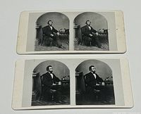 Two stereoview cards displayed showing Abraham Lincoln seated images in black and white