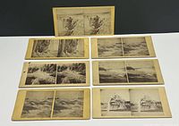 All seven Niagara Falls stereoview cards laid out in three rows showing buff mounts and black-and-white images