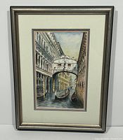 Full view of framed watercolor painting showing Venice canal scene with gondolas and bridge.
